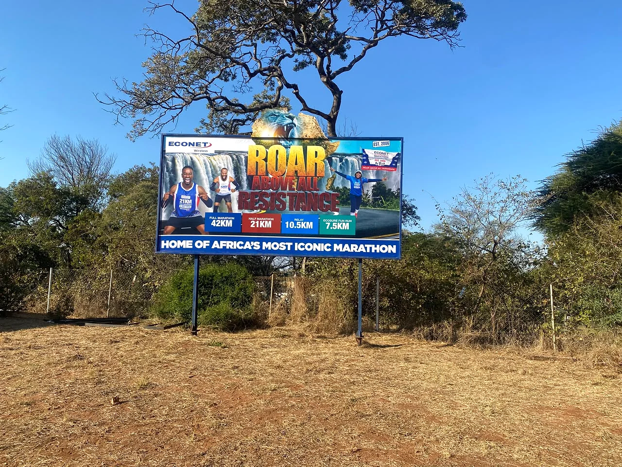 Econet Victoria Falls Marathon roadside billboard reading Roar Above All Resistance