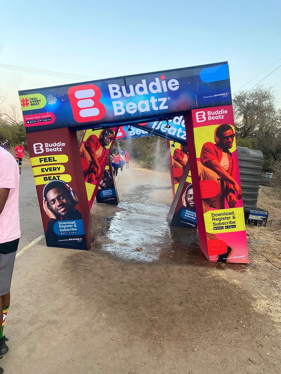 Buddie Beatz branded event entrance arch installed on a road