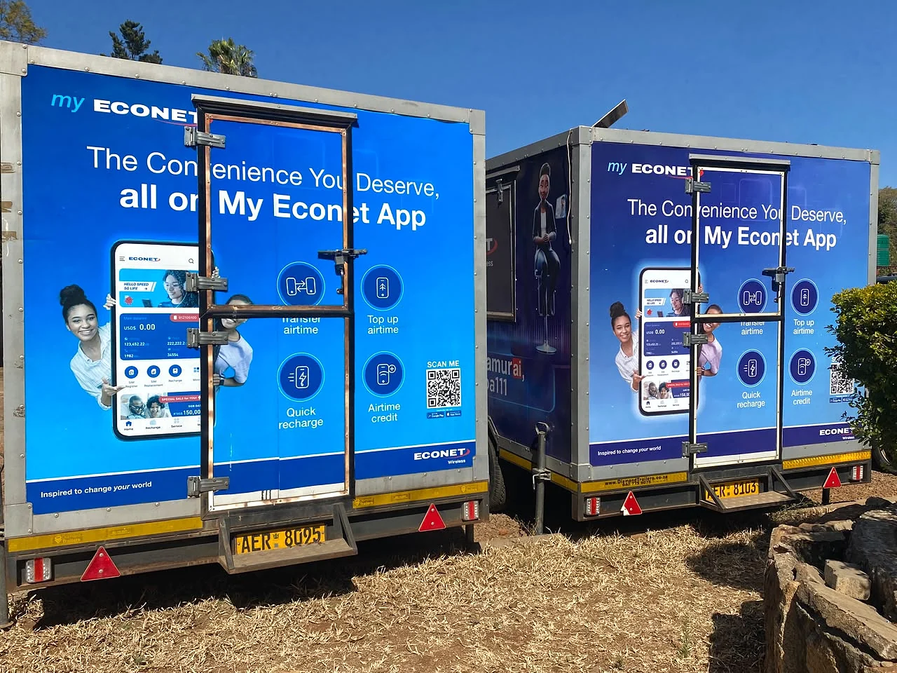 Two trailers branded with My Econet App graphics