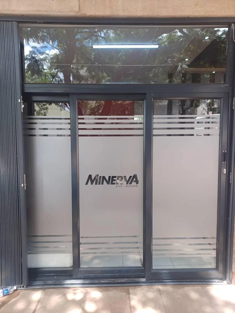 Frosted glass office doors with the Minerva Risk Advisors logo