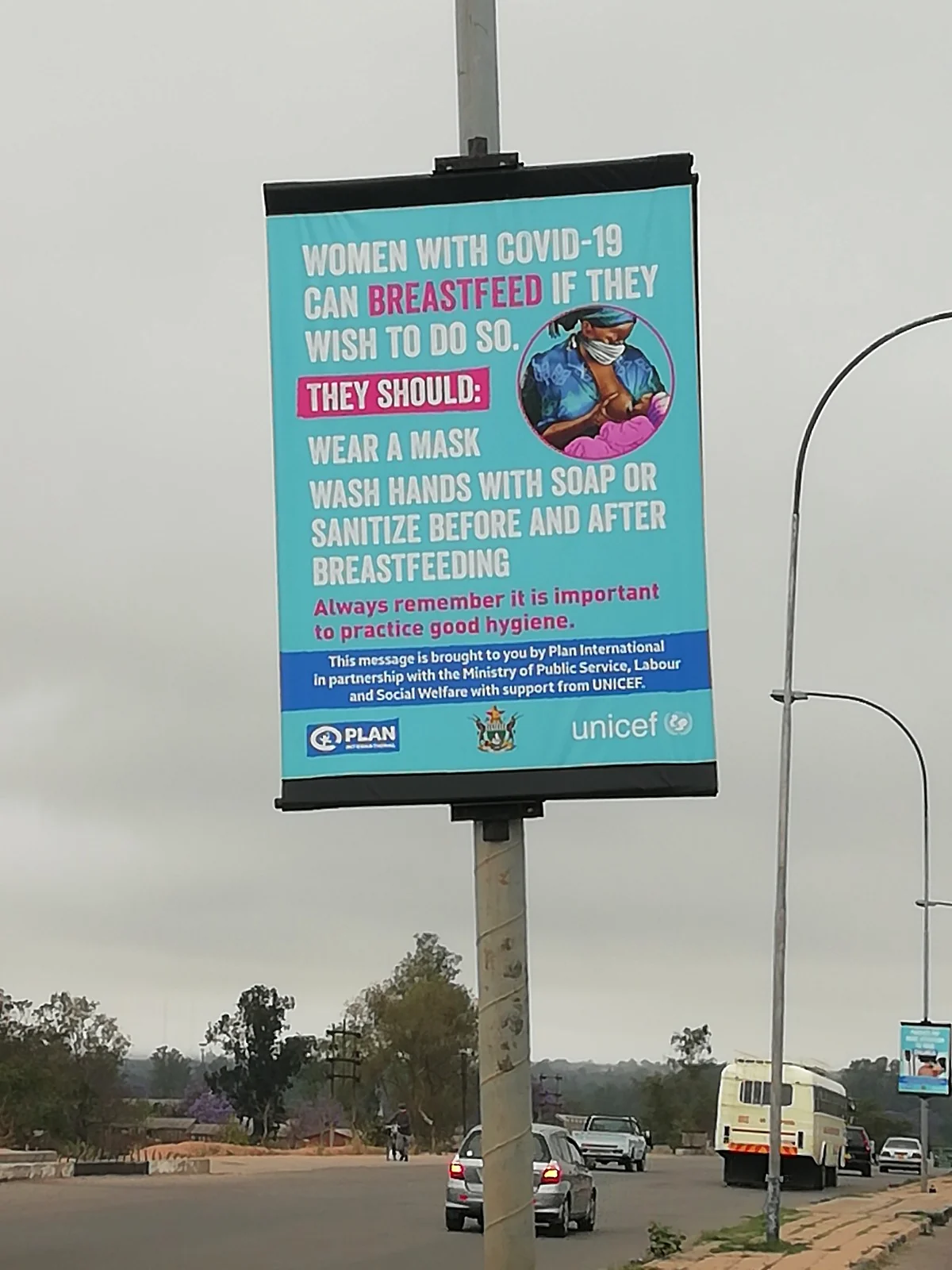Public health campaign banner mounted on a street pole